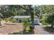 Landscaped single-story home featuring beautiful trees and a winding driveway at 4701 Nw 60Th Terrace, Ocala, FL 34482
