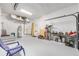 Spacious garage featuring ample storage, a work table, and organized equipment at 4701 Nw 60Th Terrace, Ocala, FL 34482
