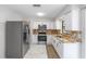Well-lit kitchen features stainless appliances, granite countertops, and white cabinets at 4701 Nw 60Th Terrace, Ocala, FL 34482