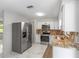 Kitchen boasts granite counters, stainless appliances, and ample cabinet space at 4701 Nw 60Th Terrace, Ocala, FL 34482