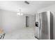 Bright, open-concept living space with a dining area and stainless steel refrigerator at 4701 Nw 60Th Terrace, Ocala, FL 34482