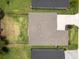 Top-down aerial view of a home's roof, driveway, and green lawn at 6235 Sw 95Th Pl, Ocala, FL 34476