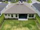 Aerial view of a backyard with a well-manicured lawn and screened-in patio at 6235 Sw 95Th Pl, Ocala, FL 34476