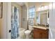 The bathroom features a single vanity with granite countertops, a toilet, and a shower at 6235 Sw 95Th Pl, Ocala, FL 34476