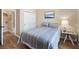 The bedroom features a queen bed, closet, and a view into the bathroom at 6235 Sw 95Th Pl, Ocala, FL 34476