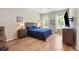 The bedroom features a queen bed, bedside tables, and an entertainment center with television at 6235 Sw 95Th Pl, Ocala, FL 34476