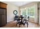 The breakfast nook features a round table, modern lighting, and natural lighting from the windows at 6235 Sw 95Th Pl, Ocala, FL 34476