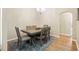 The dining room features a wooden table, chairs, chandelier, and wooden floors at 6235 Sw 95Th Pl, Ocala, FL 34476