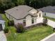 Aerial view showcasing a well-maintained home with a green lawn and a charming landscape at 6235 Sw 95Th Pl, Ocala, FL 34476
