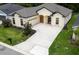 Aerial view of a lovely home highlighting the large driveway and manicured landscaping at 6235 Sw 95Th Pl, Ocala, FL 34476