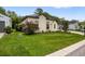 Charming home with a well-maintained front lawn, flowering bushes, and tasteful landscaping at 6235 Sw 95Th Pl, Ocala, FL 34476