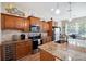 The kitchen features granite countertops, stainless steel appliances, and a breakfast bar at 6235 Sw 95Th Pl, Ocala, FL 34476