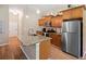 The kitchen features stainless steel appliances, wood floors, granite countertops, and a large island at 6235 Sw 95Th Pl, Ocala, FL 34476