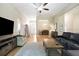 Spacious living room featuring hardwood floors, a ceiling fan, and abundant natural light at 6235 Sw 95Th Pl, Ocala, FL 34476