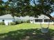 Spacious backyard featuring lush green grass and a hammock under a mature tree at 6925 Nw Highway 225A, Ocala, FL 34482