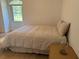 Cozy bedroom with neutral color palette, natural light, comfortable bed, hardwood floors, and minimalist decor at 6925 Nw Highway 225A, Ocala, FL 34482