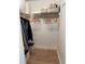 Organized closet featuring wooden hangers, shelves, and woven baskets for optimal storage solutions at 6925 Nw Highway 225A, Ocala, FL 34482