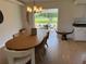 Charming dining room with a modern light fixture and views of the outdoor screened patio at 6925 Nw Highway 225A, Ocala, FL 34482