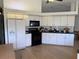 Well-lit kitchen featuring white cabinetry, modern appliances, and durable countertops, blending style with functionality at 6925 Nw Highway 225A, Ocala, FL 34482