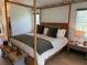 Spacious bedroom with a four-poster bed, neutral decor, and lots of natural light at 6925 Nw Highway 225A, Ocala, FL 34482