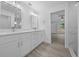 Elegant bathroom with double vanity sinks, white cabinets, and a marble-tiled shower for a luxurious experience at 7 Walnut Pl, Ocala, FL 34480