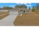 Charming single-story home with a spacious driveway and attached two-car garage at 7 Walnut Pl, Ocala, FL 34480