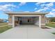 Open garage displaying neutral colors, an automatic door opener, and a smooth concrete driveway at 7 Walnut Pl, Ocala, FL 34480