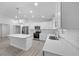 Modern kitchen with white cabinets, stainless steel appliances, and a center island at 7 Walnut Pl, Ocala, FL 34480