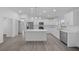 Bright, open kitchen with a large island, stainless steel appliances, and modern white cabinets and countertops at 7 Walnut Pl, Ocala, FL 34480
