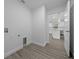 Well-lit laundry room with modern flooring, offering convenience and practicality for everyday chores at 7 Walnut Pl, Ocala, FL 34480