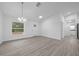 Well-lit living room with stylish light fixture and easy access to bathroom and bedrooms at 7 Walnut Pl, Ocala, FL 34480