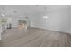 Expansive living area with sleek flooring, modern lighting, and sliding glass doors at 7 Walnut Pl, Ocala, FL 34480