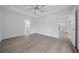 The primary bedroom has a tray ceiling, fan, and leads to the kitchen and primary bathroom through separate doorways at 7 Walnut Pl, Ocala, FL 34480