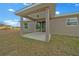 Covered patio with concrete flooring, offering an inviting outdoor lounge space at 7 Walnut Pl, Ocala, FL 34480