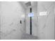 A large walk-in shower featuring rainfall shower head, modern tile, and a convenient built-in niche at 7 Walnut Pl, Ocala, FL 34480