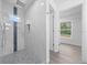 Walk-in shower with rainfall shower head, mosaic accent tiles, and a modern design, leading to a walk-in closet at 7 Walnut Pl, Ocala, FL 34480