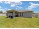 Lush backyard featuring a covered patio, green grass, and privacy fence at 7442 Sw 129Th Ln, Ocala, FL 34473