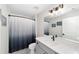 Bright bathroom featuring a stylish vanity, sleek fixtures, and a shower with an ombre curtain at 7442 Sw 129Th Ln, Ocala, FL 34473