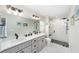 Modern bathroom with double vanity, sleek countertops, and a glass-enclosed shower with tile surround at 7442 Sw 129Th Ln, Ocala, FL 34473
