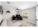 Bedroom featuring a ceiling fan, a window with a view to the backyard, and a comfortable sofa at 7442 Sw 129Th Ln, Ocala, FL 34473