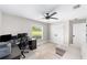 Bedroom featuring a ceiling fan, a window with a backyard view, and lots of storage with a closet at 7442 Sw 129Th Ln, Ocala, FL 34473