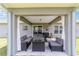 Inviting covered patio with stylish outdoor furniture and a view of the spacious backyard at 7442 Sw 129Th Ln, Ocala, FL 34473