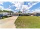 Attractive home with a manicured lawn, ample driveway space, and convenient RV parking at 7442 Sw 129Th Ln, Ocala, FL 34473