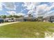 Well-manicured front lawn and landscaping in this home, with ample driveway parking at 7442 Sw 129Th Ln, Ocala, FL 34473