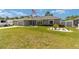 Charming home featuring a manicured lawn and well-maintained landscaping with white rock features at 7442 Sw 129Th Ln, Ocala, FL 34473