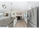 Open layout kitchen and dining area with stainless steel appliances, granite countertops, and modern decor at 7442 Sw 129Th Ln, Ocala, FL 34473