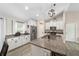 Bright kitchen with granite countertops, stainless steel appliances and a large central island at 7442 Sw 129Th Ln, Ocala, FL 34473