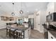 Kitchen boasts pendant lighting, stainless steel appliances, granite countertops, and seating at the central island at 7442 Sw 129Th Ln, Ocala, FL 34473