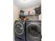 Modern laundry room featuring front loading washer and dryer at 7442 Sw 129Th Ln, Ocala, FL 34473