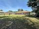 Spacious backyard with a lawn, patio area, slider, surrounded by a fence, offering ample space for outdoor activities at 7800 Sw 127Th Loop, Ocala, FL 34473